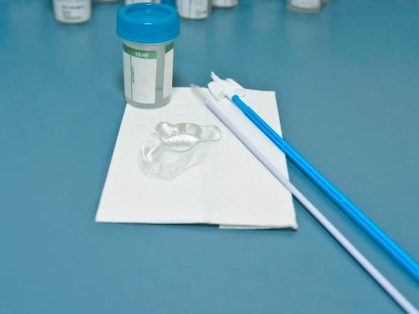 Image depicting medical equipment including a swab, specifically used in pap smears for women's health examinations.