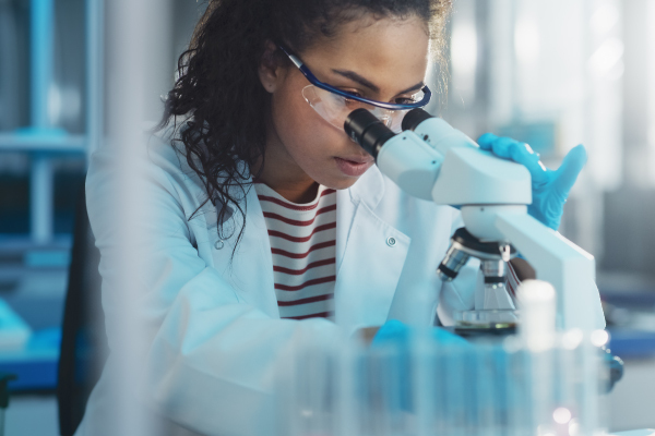 Clinician viewing samples from rayon swabs under microscope