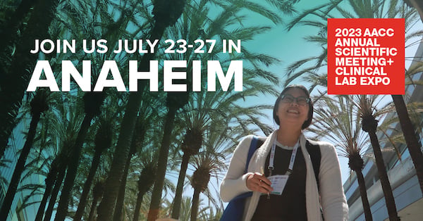 Woman with AACC event badge smiles at camera with palm tree in the brackground