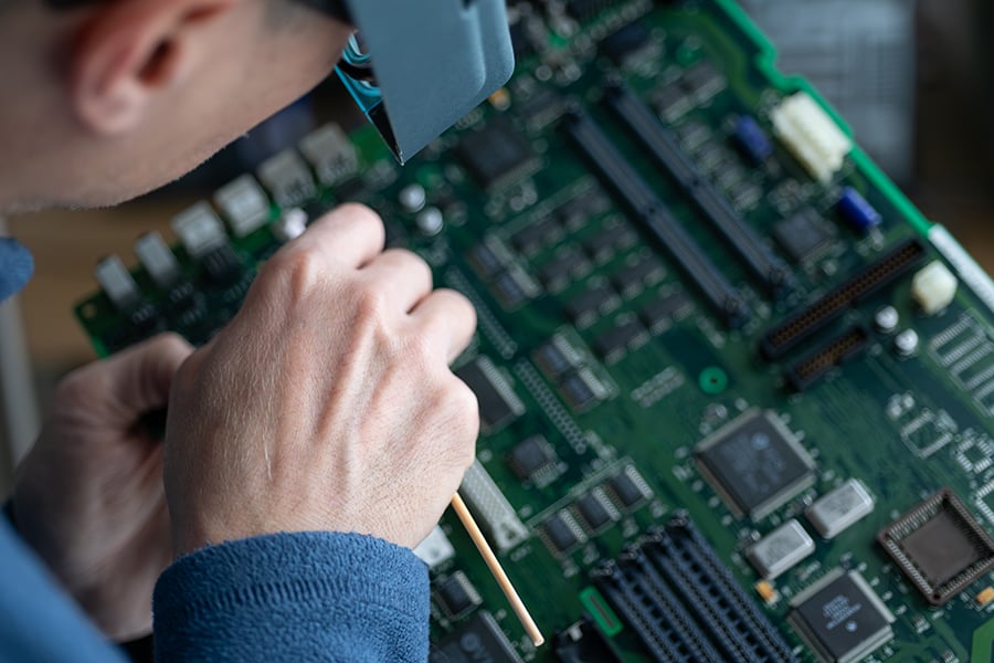 technician-cleaning-motherboard